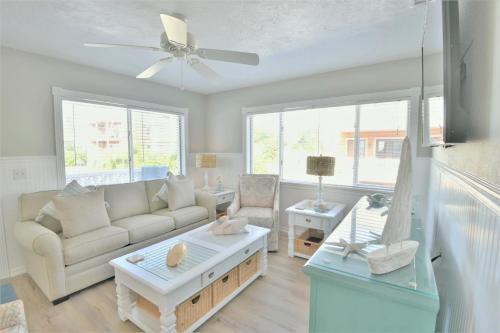 a living room with a couch and a table at Seagrass Flats in Ilexhurst
