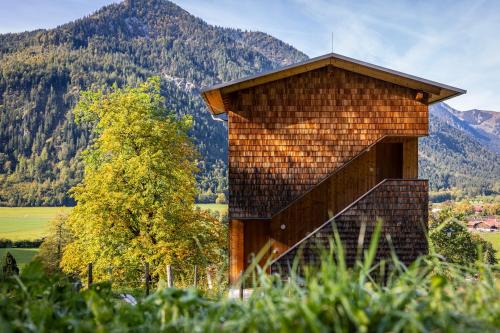 a building with a staircase in front of a mountain at Tannerhof - Mein Versteck in den Bergen in Bayrischzell