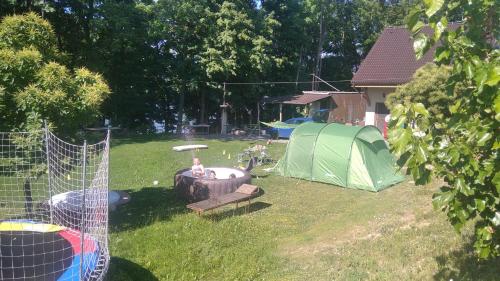 a backyard with a tent and a fire hydrant and a grill at Chata dobrý pocit in Horné Orešany