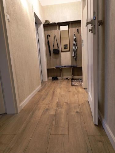 an empty hallway with wooden floors in a room at Kindermann Residence in Łódź