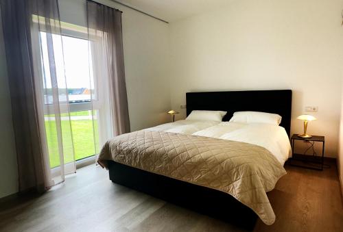 a bedroom with a large bed and a large window at Apartment Fürstenau in Fürstenau