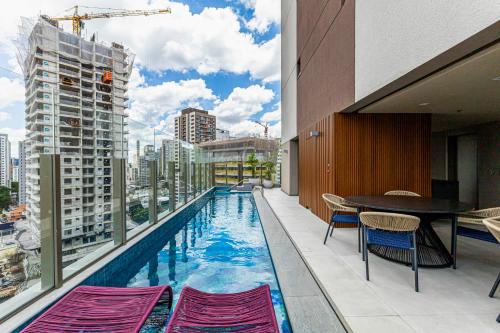a swimming pool on the balcony of a building at Charlie Atmosfera Santo Amaro in Sao Paulo