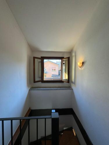 a stairway with a window in a stair case at Rovellasca Tra Como e Milano in Rovellasca