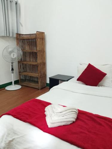 a bedroom with two beds with red and white blankets at Casablanca Nepal at Tours By Nayan in Kathmandu