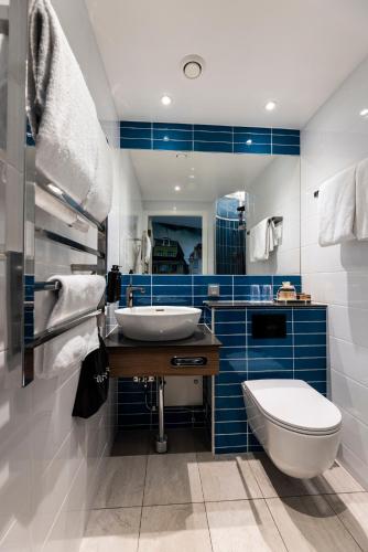 a bathroom with a toilet and a sink at ProfilHotels Central in Stockholm