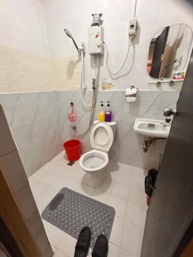 a bathroom with a toilet and a sink at 7pax, 2 AC BR,Videoke,Games,Netflix,Cook,Parking in Rodriguez