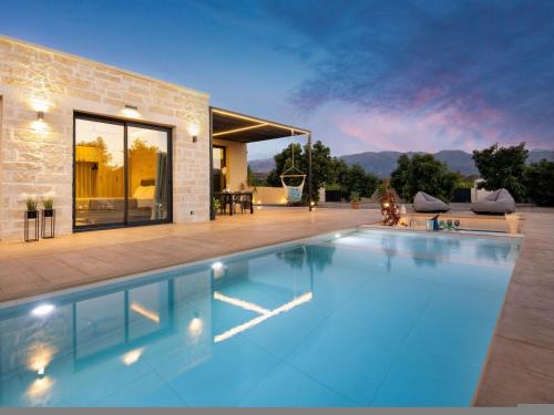 a swimming pool in front of a house at PanStel - Villa Solene with private pool in Ayiá