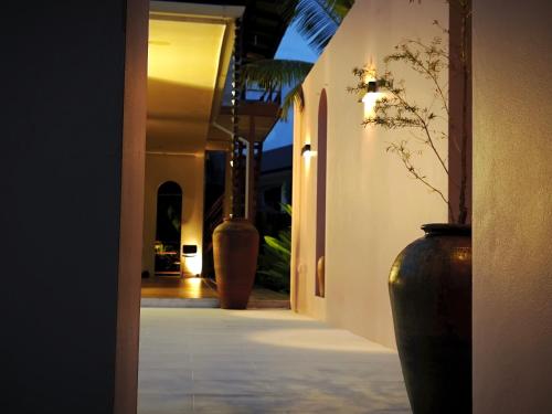 a group of vases sitting on the side of a hallway at Fieldlight Pool Villa -Rice View &private pool云上稻影 in Mae Rim