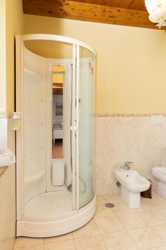 a bathroom with a shower and a toilet and a sink at Santa Maria Apartments in Forino