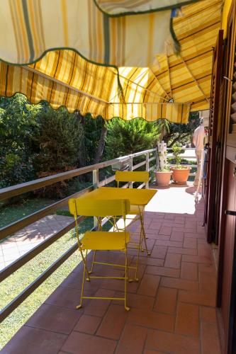 a yellow table and chairs on a balcony at Santa Maria Apartments in Forino