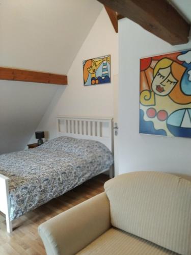 a bedroom with a bed and a couch at Artemis in Wissembourg