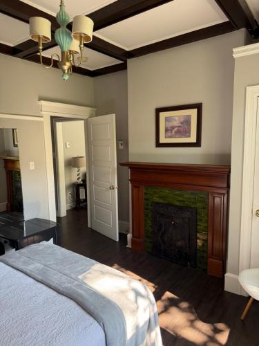 a bedroom with a fireplace and a bed at Waterfordbridge Apartments - 2 Bedroom Mainfloor in St. John's