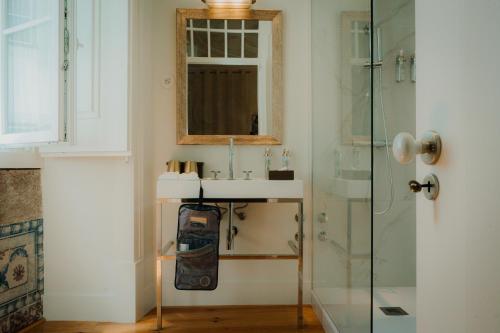 a bathroom with a sink and a glass shower at Once Upon Lisboa in Lisbon