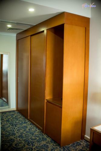 a closet with wooden doors in a room at Rehana Plaza Hotel in Cairo
