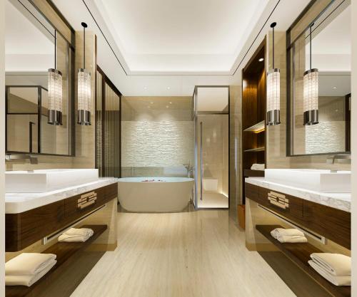 a bathroom with two sinks and a bath tub at Hotel Grand Villa Palce Near New Delhi IGI Airport in New Delhi
