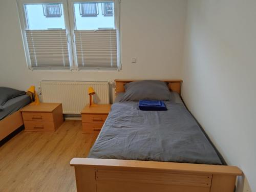 a bedroom with a bed and two night stands at Monteurzimmer Mühlheim am Main Nähe S-Bahn in Mühlheim