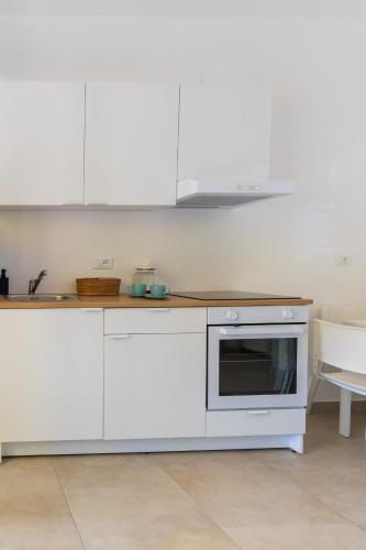 a kitchen with white cabinets and a microwave at Santa Maria Apartments in Forino