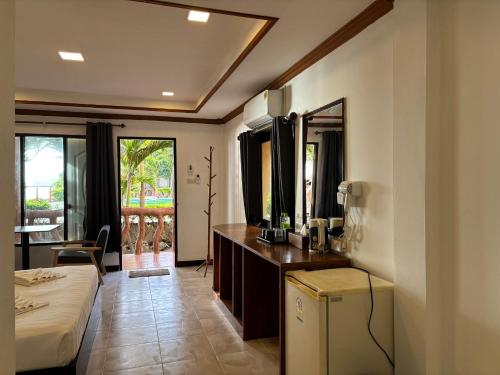 a bedroom with a bed and a dresser with a mirror at Friendly by The Sea in Haad Rin