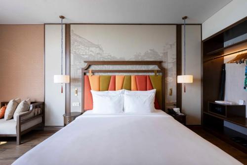 a large white bed in a hotel room at Mandala Cham Bay Mui Ne in Ấp Nhơn Hòa