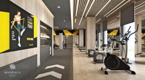 a gym with treadmills and ellipticals in a building at Mandala Cham Bay Mui Ne in Ấp Nhơn Hòa
