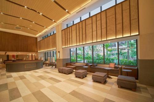 a lobby with couches and stools in a building at Mandala Cham Bay Mui Ne in Ấp Nhơn Hòa
