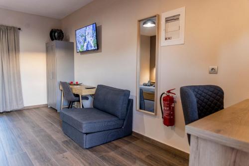 a room with a desk and a chair and a table at Meteora Living Rooms in Kastrákion
