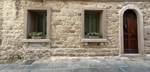 two windows on a stone building with flowers in them at AbalabÀ - Gallura Retreat - Domo in Aggius