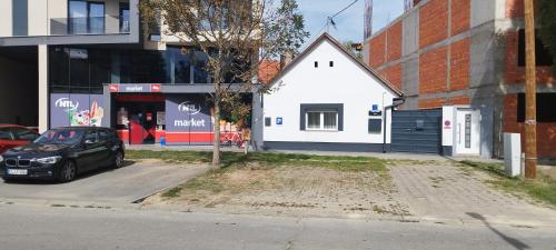 a small white house on the side of a street at Lamia in Osijek