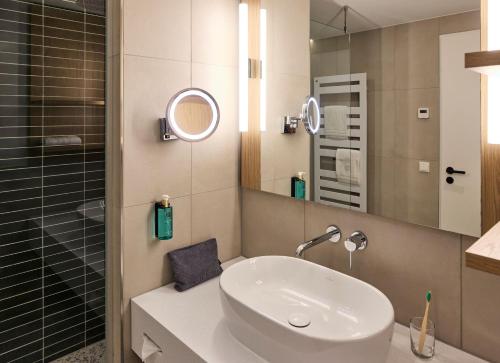 a bathroom with a sink and a mirror at ROBINSON Fleesensee in Göhren-Lebbin