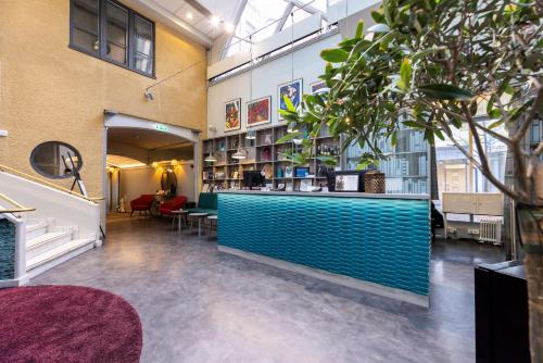 a lobby with a blue counter in a library at ProfilHotels Central in Stockholm