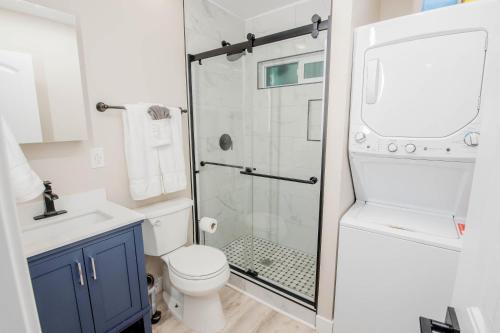 a bathroom with a shower with a toilet and a sink at Urban Zen 2 - Luxury Remodel - Gr8 Deal- WOW in San Diego