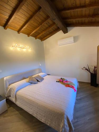 a bedroom with a bed in a room with wooden ceilings at Domus Antonii in Corchiano