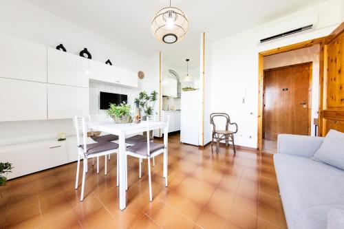 a kitchen and living room with a white table and chairs at High Views at Castel Rocchero in Castel Rocchero