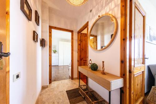 a hallway with a mirror and a wooden table at High Views at Castel Rocchero in Castel Rocchero
