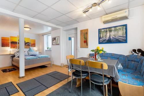 a living room with a table and chairs and a bed at Ferienwohnung, 50qm, Terrasse in Sexau