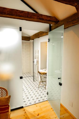 a bathroom with a shower and a glass door at Ugron Castle Fiatfalva in Cristuru Secuiesc