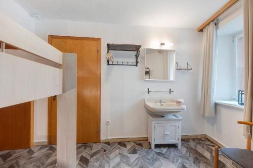 a bathroom with a sink and a mirror at Ferienhaus Zum Burgfried in Neuerburg
