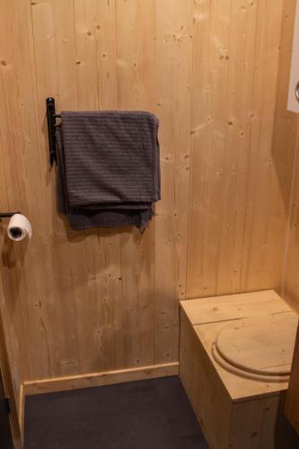 a wooden bathroom with a towel hanging on the wall at Le Bosquet des Dômes - Panorama des Puys à Cheval in Châtel-Guyon