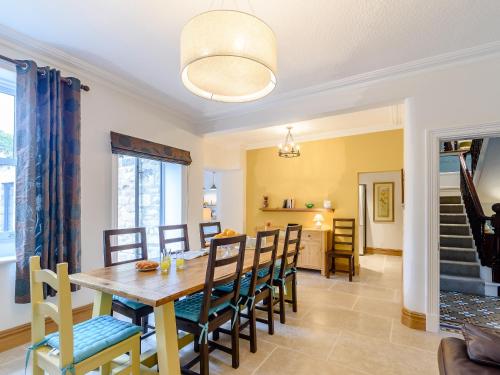 a dining room and living room with a table and chairs at Temple House in West Burton