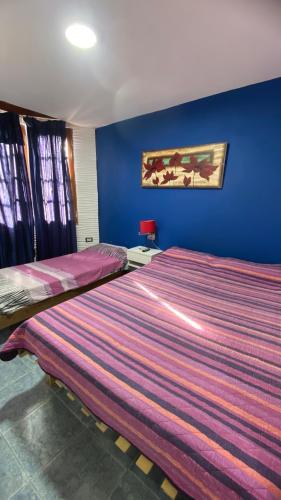 En eller flere senge i et værelse på Lyfrago Departamento Temporario