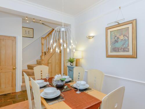 a dining room with a wooden table and chairs at Number 1 Admiralty Cottages in Alverstoke