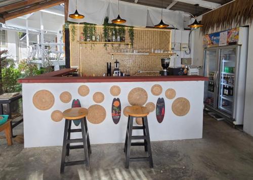 a bar with two stools and a counter withmbermbermbermbermbermber at White house bailan resort in Ko Chang