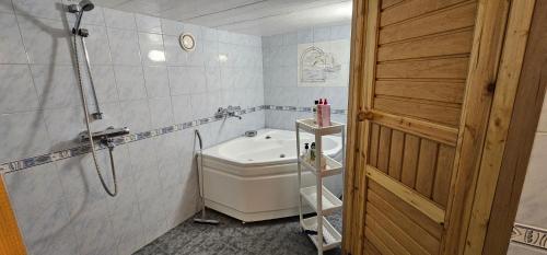a bathroom with a toilet and a sink and a door at Air contioned and furnished half of semi detached house in Rauma