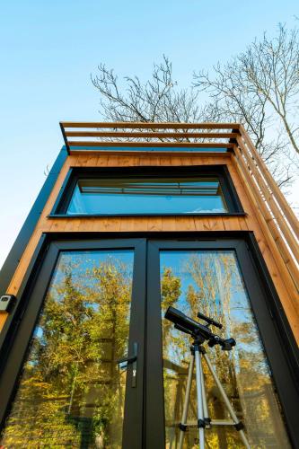 a building with a camera in front of a window at La Clairière de Peylenc - Refuge en Velay in Saint-Pierre-Eynac