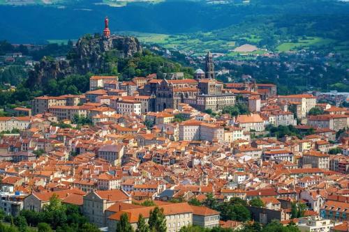a view of a city with red roofs at La Clairière de Peylenc - Refuge en Velay in Saint-Pierre-Eynac