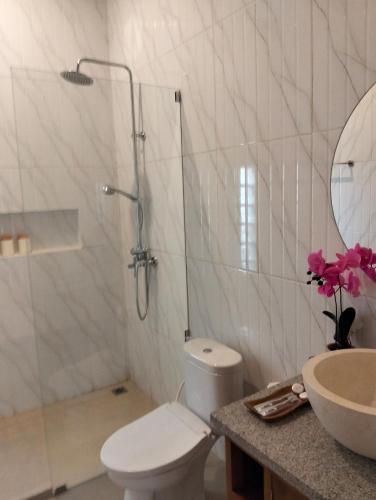 a bathroom with a shower and a toilet and a sink at The Swasti Villa Ubud in Tegalalang