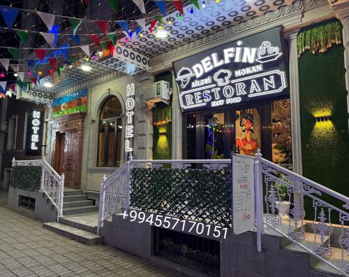 a store with a sign on the front of a building at Delfin Hotel & Restaurants & Spa in Ganja