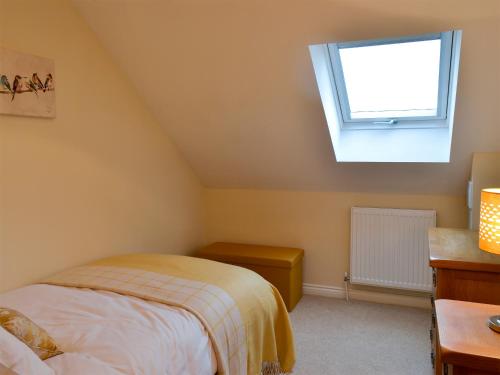 a bedroom with a bed and a window at Wheatfield House in Kilmaurs