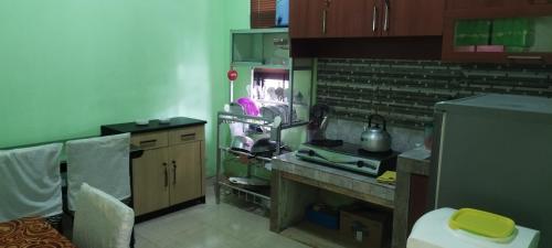 a kitchen with a sink and a counter top at Omah Semaki in Yogyakarta