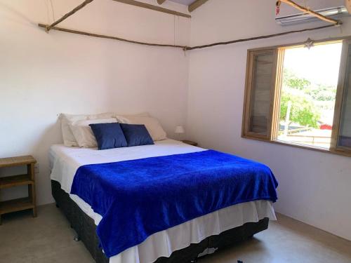 Llit o llits en una habitació de Casa e Chalé raio de sol